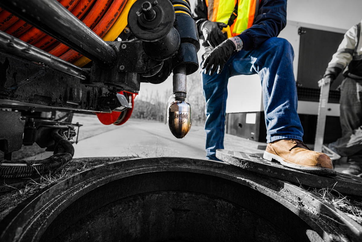 Man getting ready to clean a line using a Reaper sewer nozzle