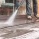 Man Pressure Washing a Deck